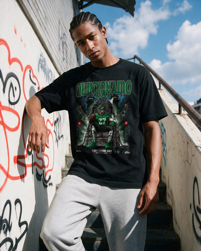 Model wearing a Quinyonamo Bay shirt featuring Quinyon Mitchell. Philadelphia Eagles football fan tshirt.